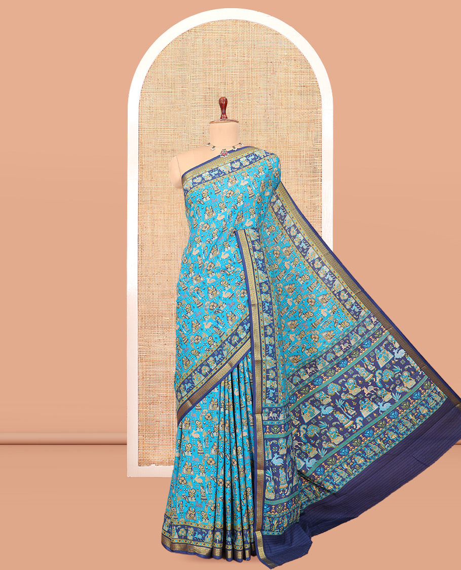 Blue Printed Silk Saree, Adorned with a Village-Themed Print, a Contrast Traditional Zari Border, Striped Pallu, and a Contrast Blouse