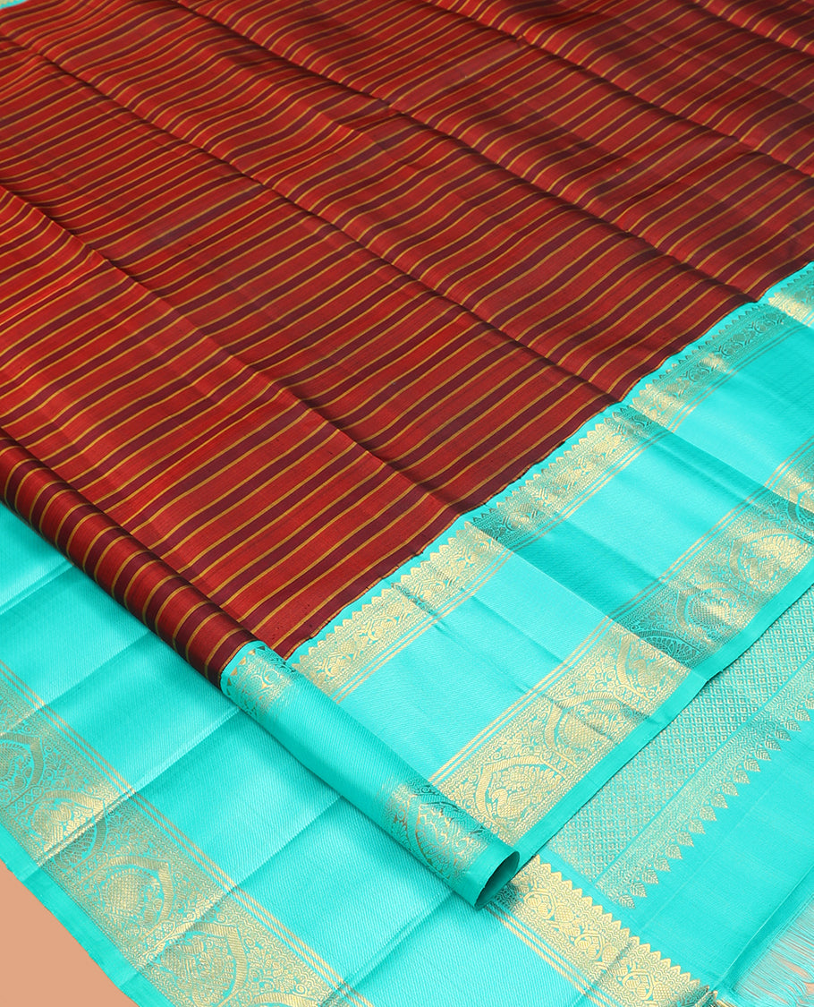 Brown Striped Kanchipuram Silk Saree, Complemented by a Contrast Border of Rekku, Muthu, Neli, Mayil, and Arumbu Manga Designs, Grand Pallu, and a Contrast Blouse