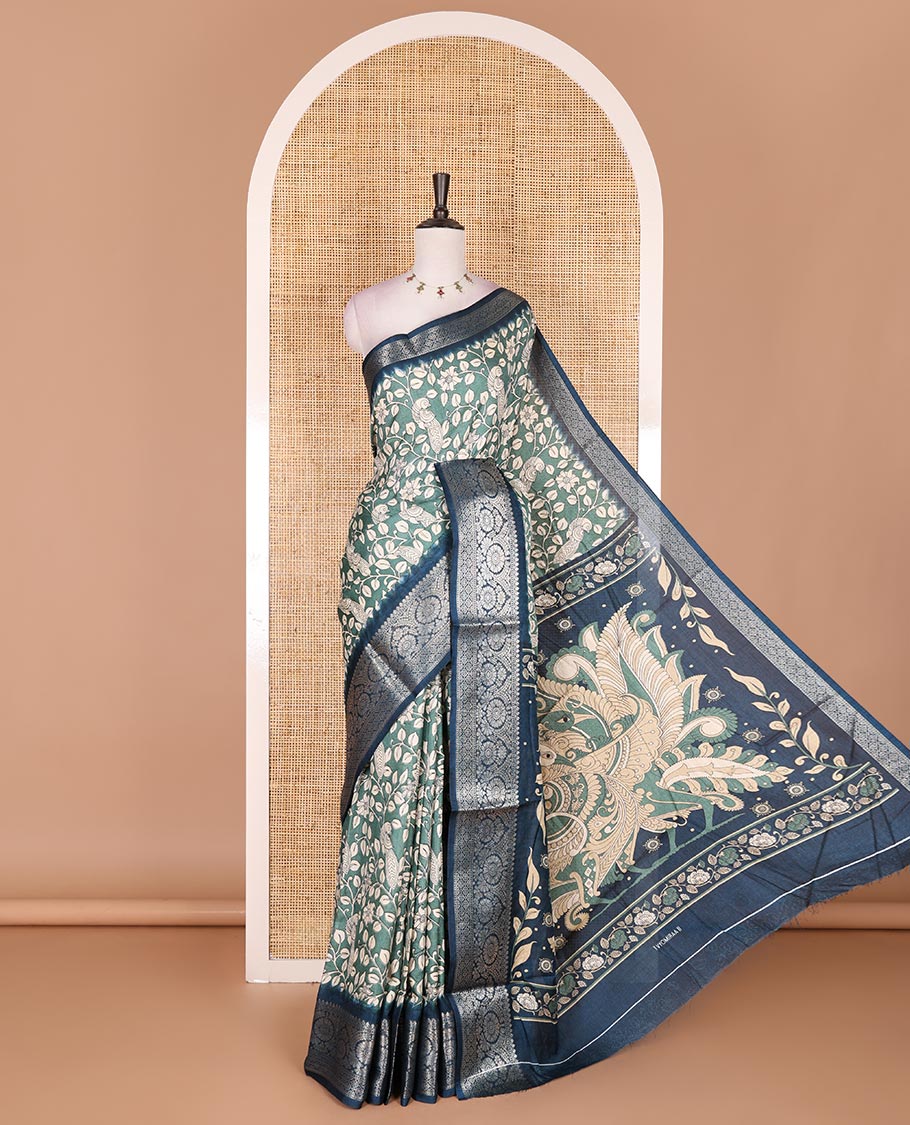 Green kalamkari floral vine and peacock printed dola silk saree, contrast traditional zari border, peacock printed pallu, and floral vine print blouse