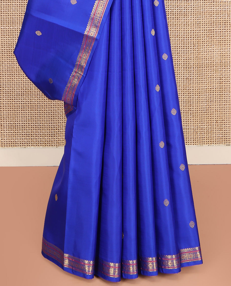 Royal Blue Kanchipuram Silk Saree, Elevated with Zari Buttas All Over Its Body, Highlighted by Zari Border of Salngai, Muthu, and Chakram Designs, Pallu of Mayil Kann Design, and Paired with a Matching Blouse