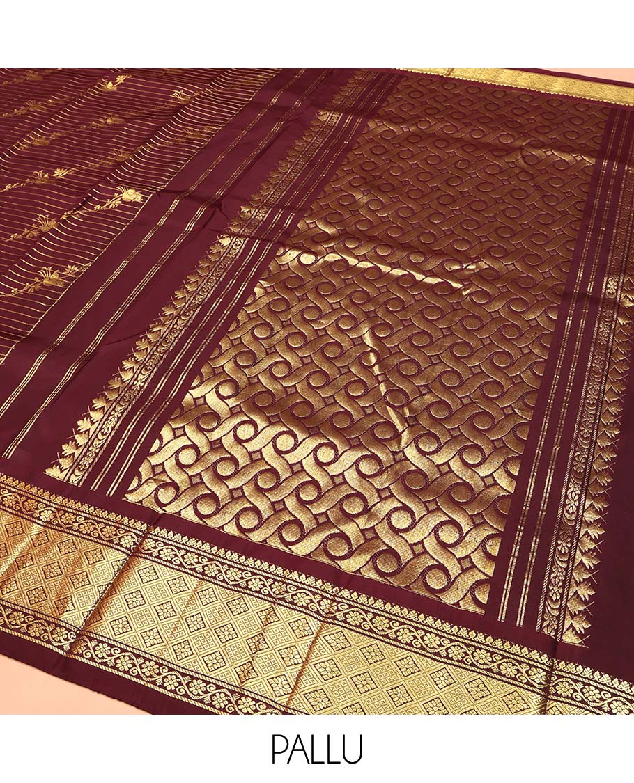 Maroon Kanchipuram Silk Saree, Gleamed Up with Zari Stripes and Bird Buttas on Its Body, Highlighted by a One-Sided Border of Kodi Visiry, and Jaal Designs, Pallu of Geometric Designs, and Comes Without a Blouse