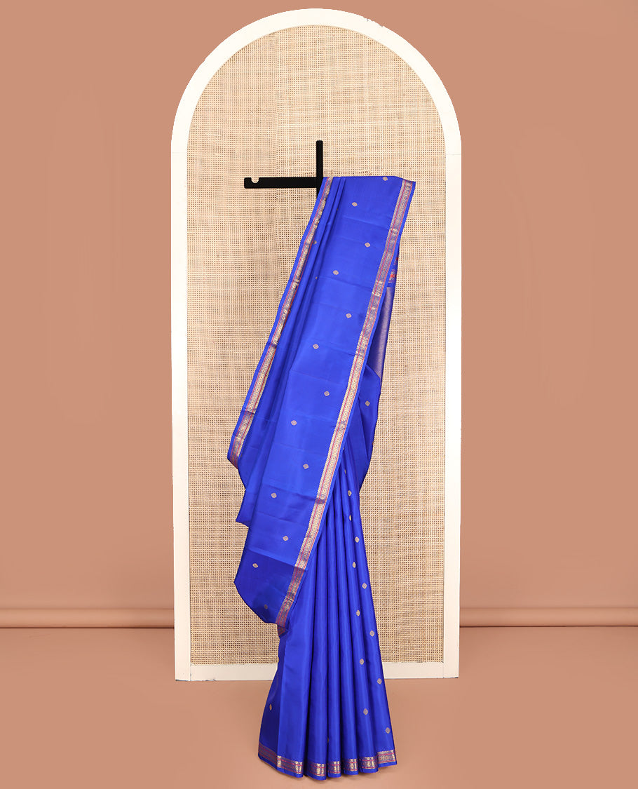 Royal Blue Kanchipuram Silk Saree, Elevated with Zari Buttas All Over Its Body, Highlighted by Zari Border of Salngai, Muthu, and Chakram Designs, Pallu of Mayil Kann Design, and Paired with a Matching Blouse