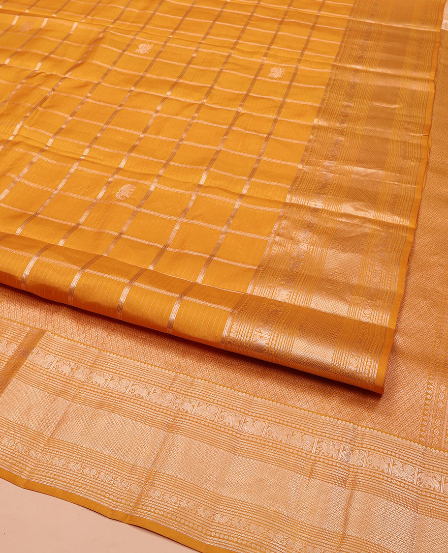 Yellow Vasundhara Silk Saree, Enriched with Zari Butta Enclosed Checked Design All Over Its Body, Highlighted by Zari Border of Thilakam Mokku, Muthu, Mayil, Yaanai, and Mayil Kann Designs, Grand Jaal Pallu, and Paired with a Matching Blouse