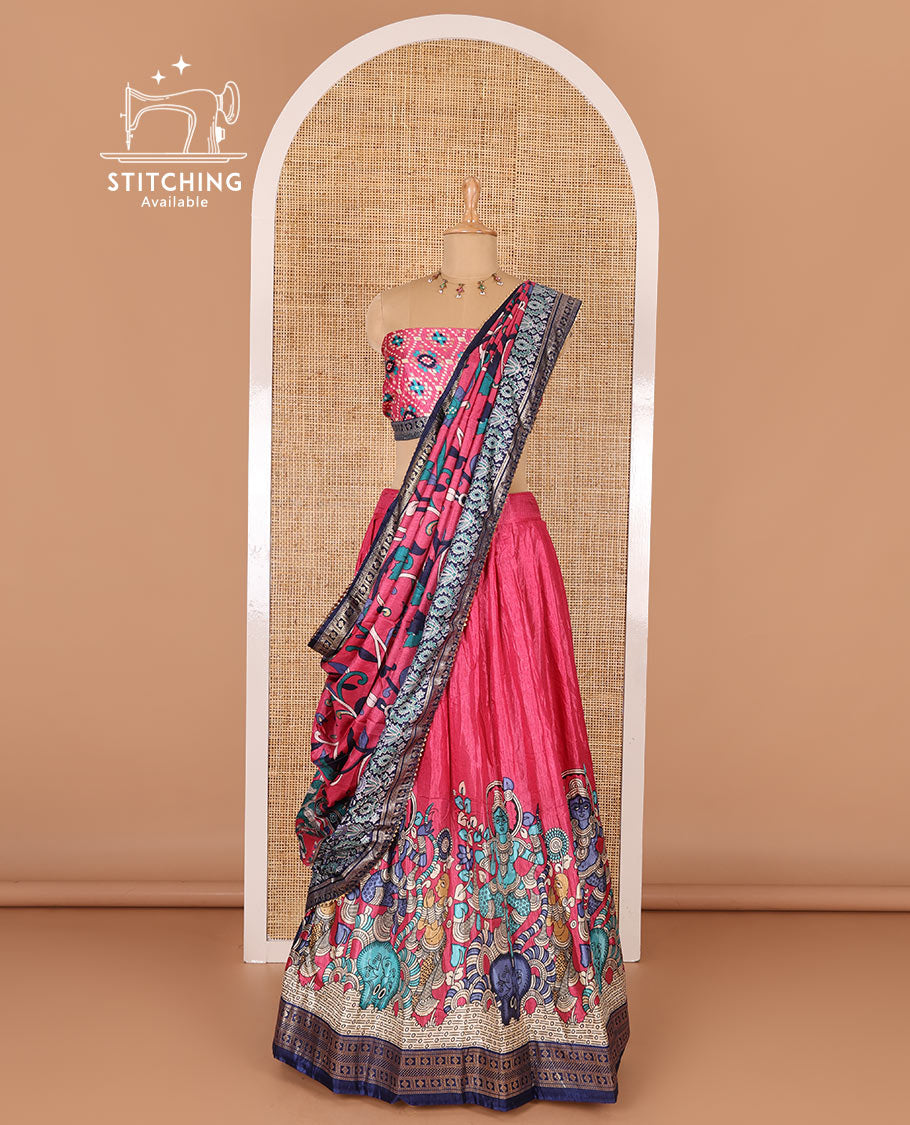 Pink semi-tussar half-saree, kalamkari human figurines printed with a contrast geometric bordered skirt, patola printed blouse, and kalamkari floral vine printed dhavani