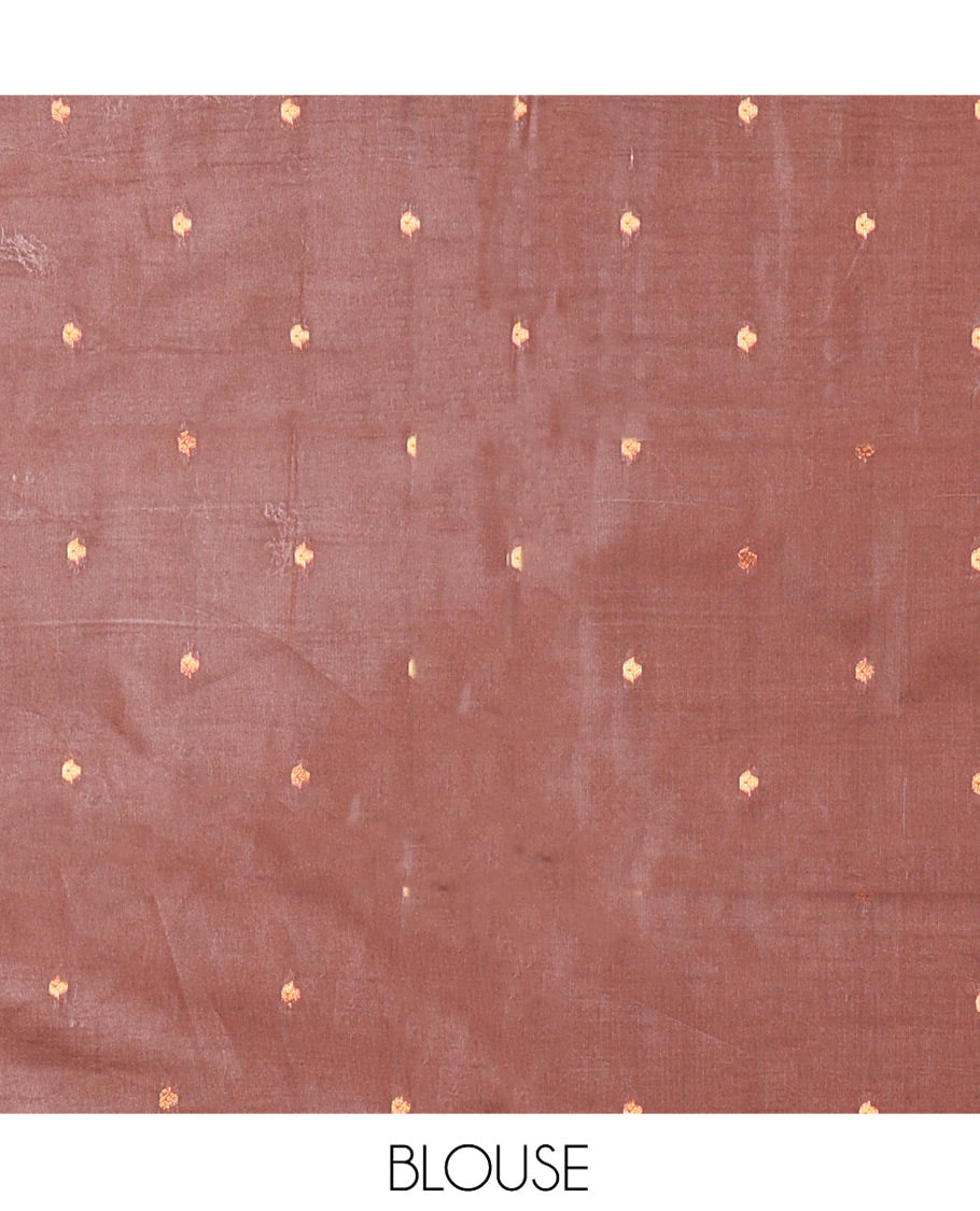 Rust Orange Kanchi Silk Saree Adorned with Zari Buttas All Over Its Body, Complemented by Contrast Temple Motifs Woven Zari Border, Scintillating Pallu of Jaal Designs, and Paired with a Contrast Blouse