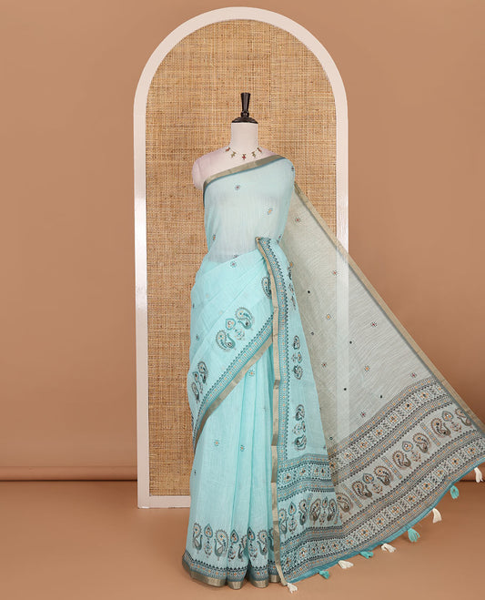 Sea green buttas with mirror work linen saree, zari border with peacock motifs print, printed mirror work pallu, and matching blouse