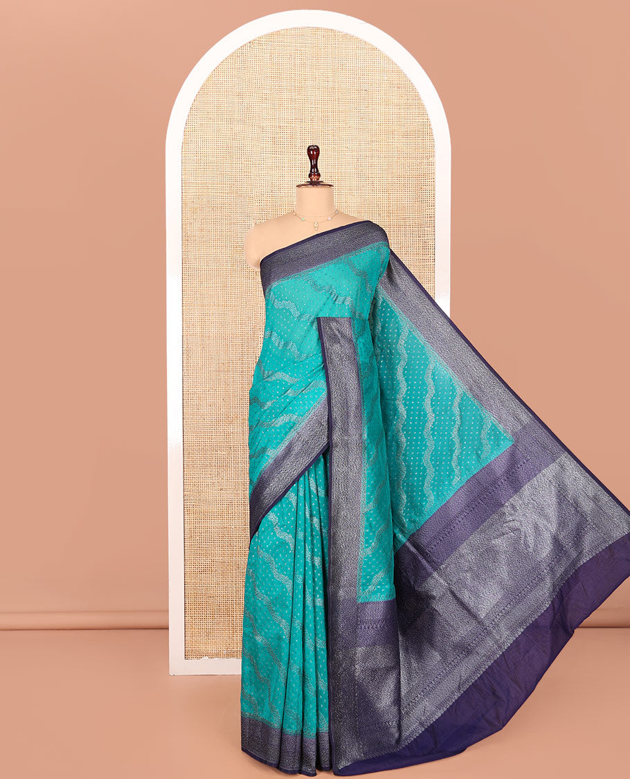 Blue Georgette Saree, Subtly Highlighted with Buttas and Diagonal Zig-Zag Stripes on Its Body, Complemented by a Contrast Gleaming Zari Textured Border, Pallu Adorned with Zari Designs, and Paired with a Contrast Blouse