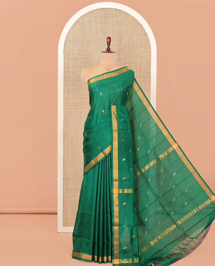 Green Uppada Silk Saree Entralled with Paisley Zari Buttas, Complemented by Bavanji Border, Pallu Depicting Zari Buttas, and Paired with a Matching Blouse