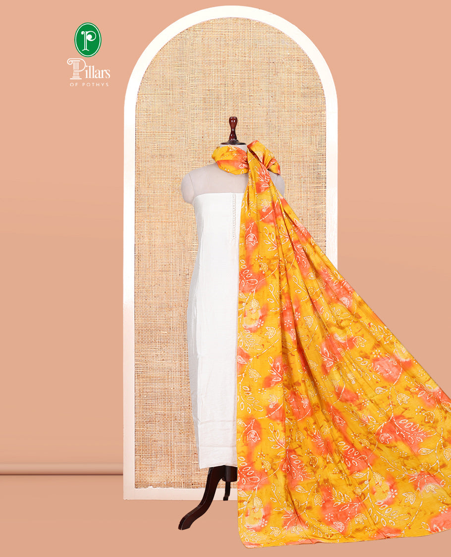 Cream-Orange Kerala Cream Mul Chanderi Material Churidar Features Pom-Pom Neckline Top, a Contrast Batik Floral Printed Bottom, and Dupatta