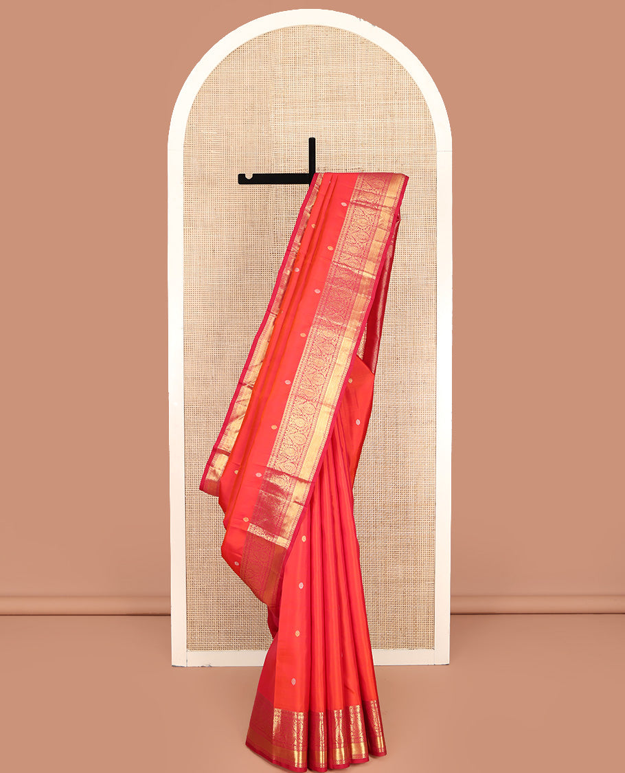 Orange Kanchipuram Silk Saree, Adorned with Zari Buttas All Over Its Body, Complemented by Contrast Border of Kamalam, Thilakam, and Mayil Kann Designs, Grand Jaal Pallu, and Paired with a Contrast Blouse