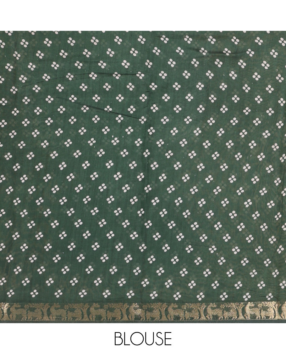 Green Muslin Cotton Saree Spotlighted with Zig-Zag Shibori Patterns Prints, Complemented by a Contrast Border of Deer Motifs in Zari, Pallu Decked Up with Scenery Print, and Paired with a Contrast Polka Dots Printed Blouse