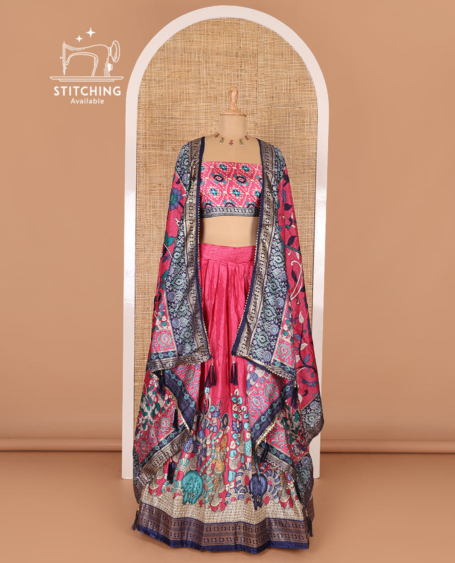 Pink semi-tussar half-saree, kalamkari human figurines printed with a contrast geometric bordered skirt, patola printed blouse, and kalamkari floral vine printed dhavani