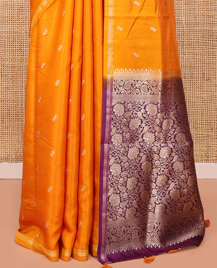 Orange Satin Silk Saree, Subtly Sparkled with Buttas All Over Its Body, a Subtle Piping Border, Complemented by a Contrast Pallu of Floral-Paisley Designs in Zari, and Paired with a Contrast Blouse