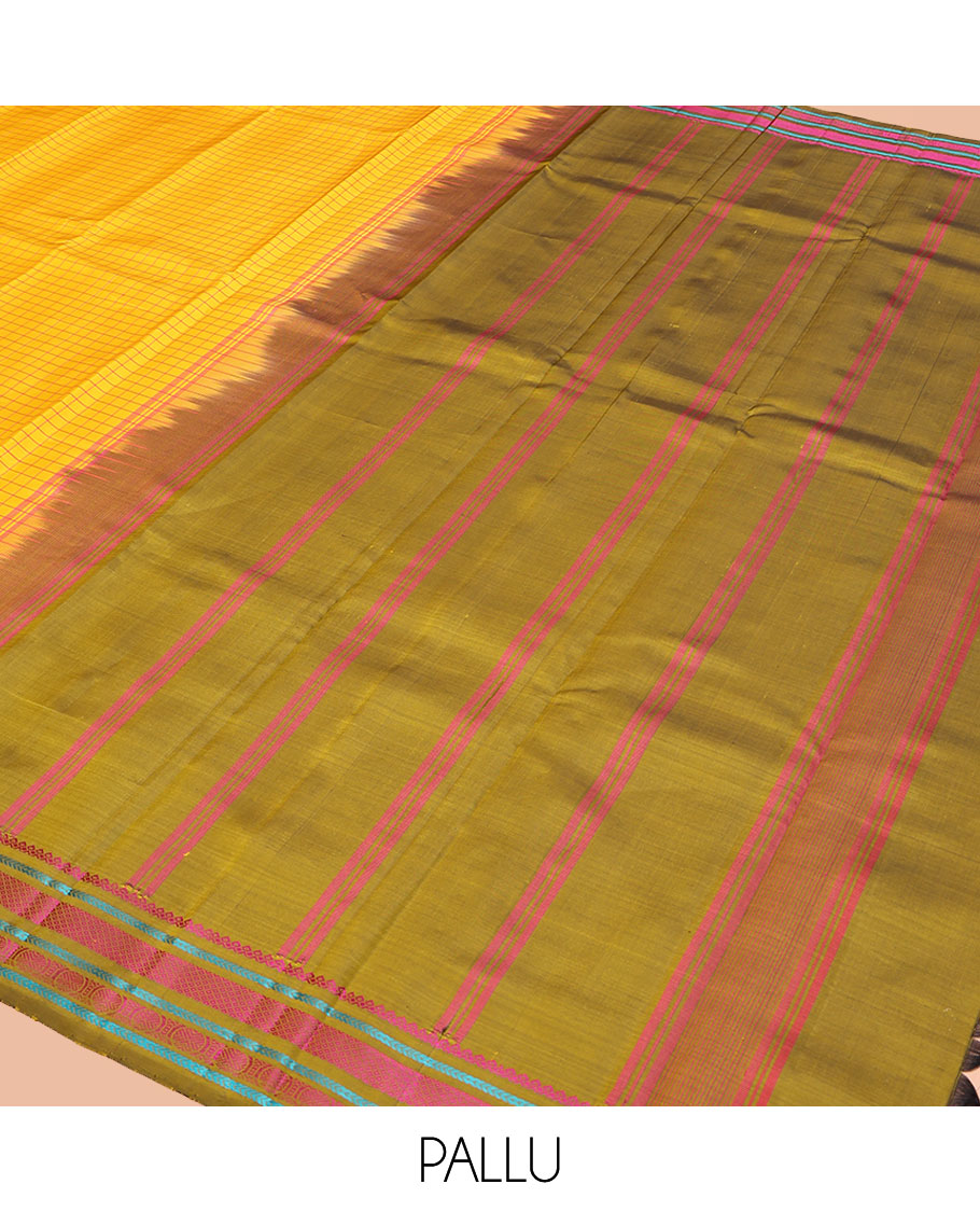 Yellow kanchipuram silk saree, subtly sparkled with checked design on its body, complemented by a contrast border of salngai, kathir, mayil kann, kathir, and rudraksham designs, a subtly striped pallu, and paired with a contrast blouse