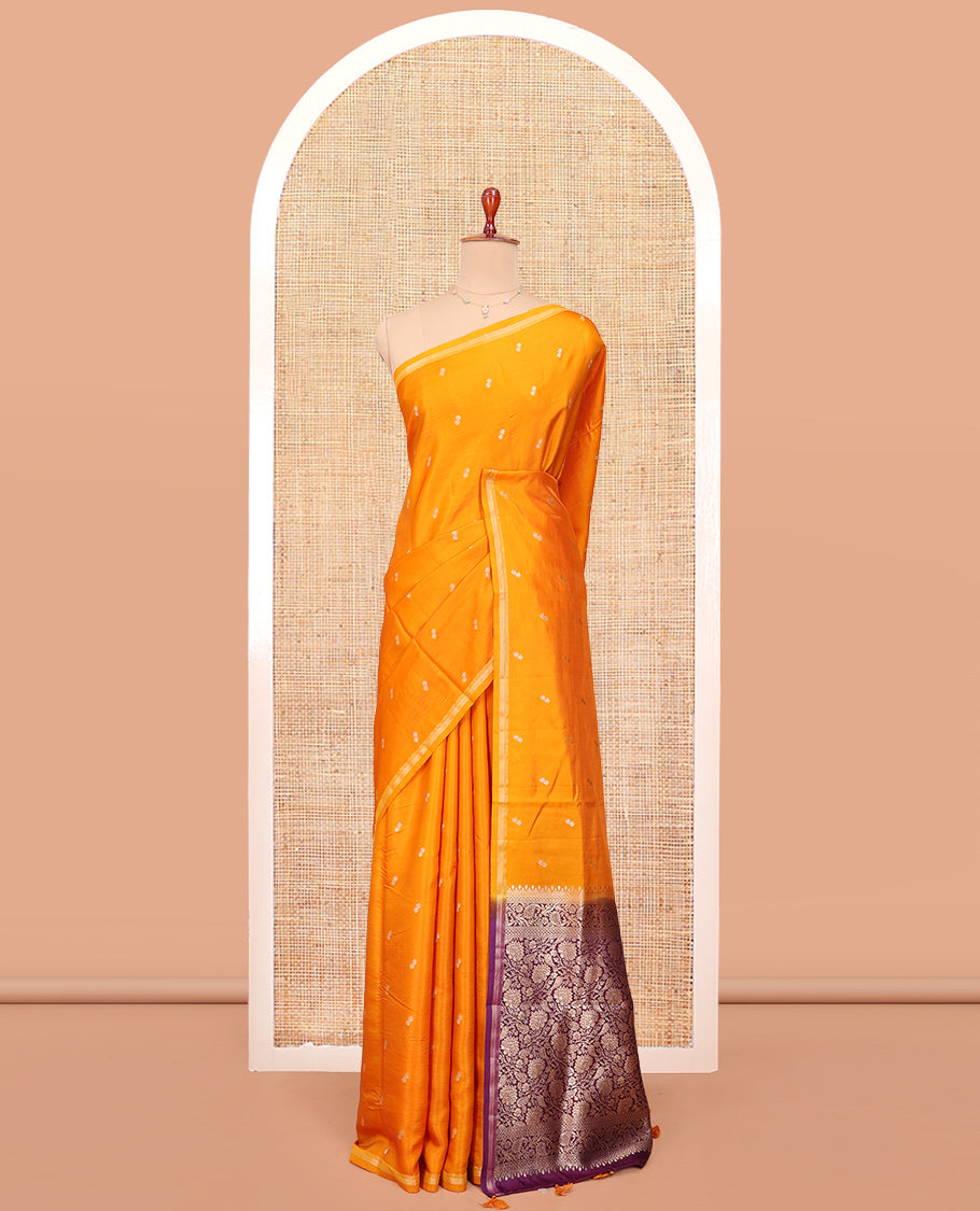 Orange Satin Silk Saree, Subtly Sparkled with Buttas All Over Its Body, a Subtle Piping Border, Complemented by a Contrast Pallu of Floral-Paisley Designs in Zari, and Paired with a Contrast Blouse
