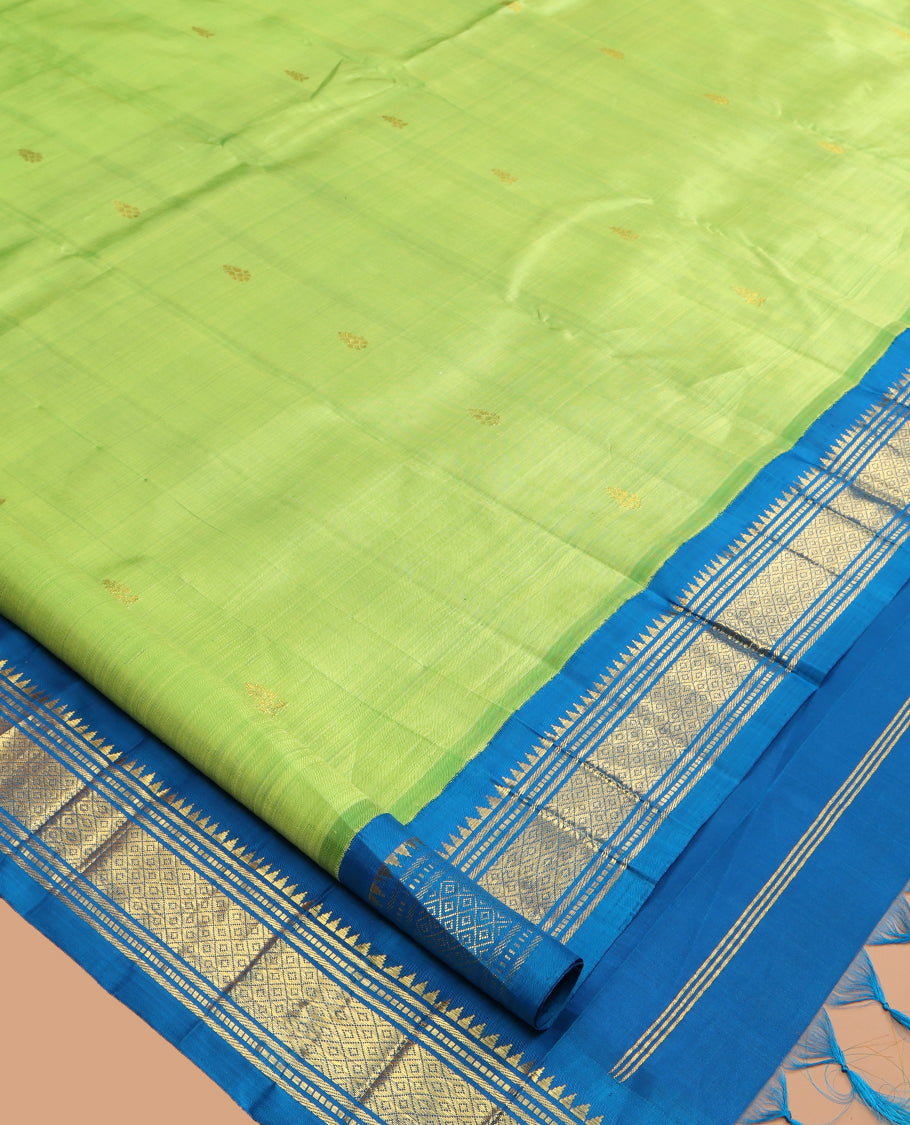 Green Kanchipuram Silk Saree, Subtly Woven with Zari Buttas, a Contrast Korvai One-Sided Border of Rekku, Banaras, Muthu, and Mayil Kann Design, Zari Design Pallu, and No Blouse