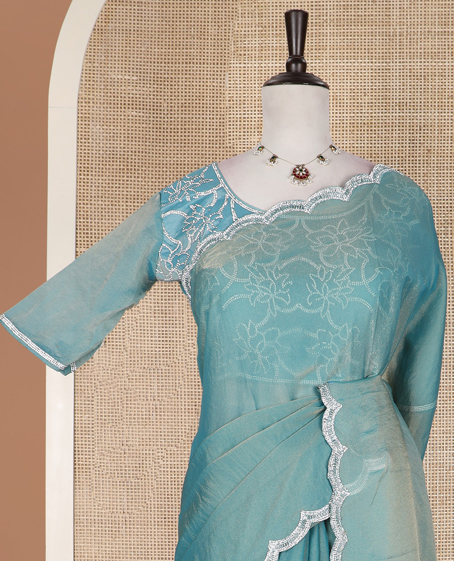 Blue plain designer saree, scallop embroidered border, and a matching elbow sleeve blouse of floral vine in micro-stones