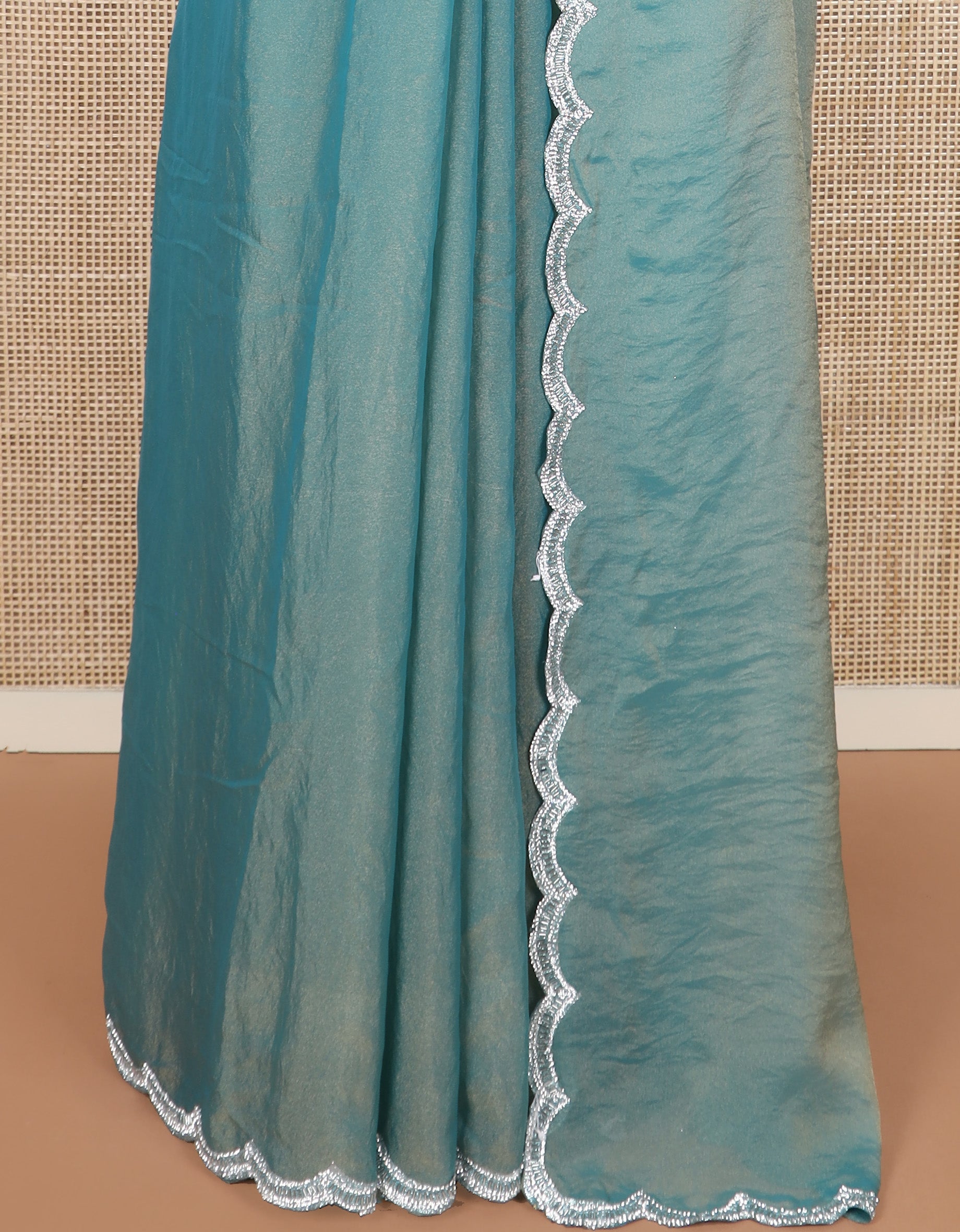 Blue plain designer saree, scallop embroidered border, and a matching elbow sleeve blouse of floral vine in micro-stones
