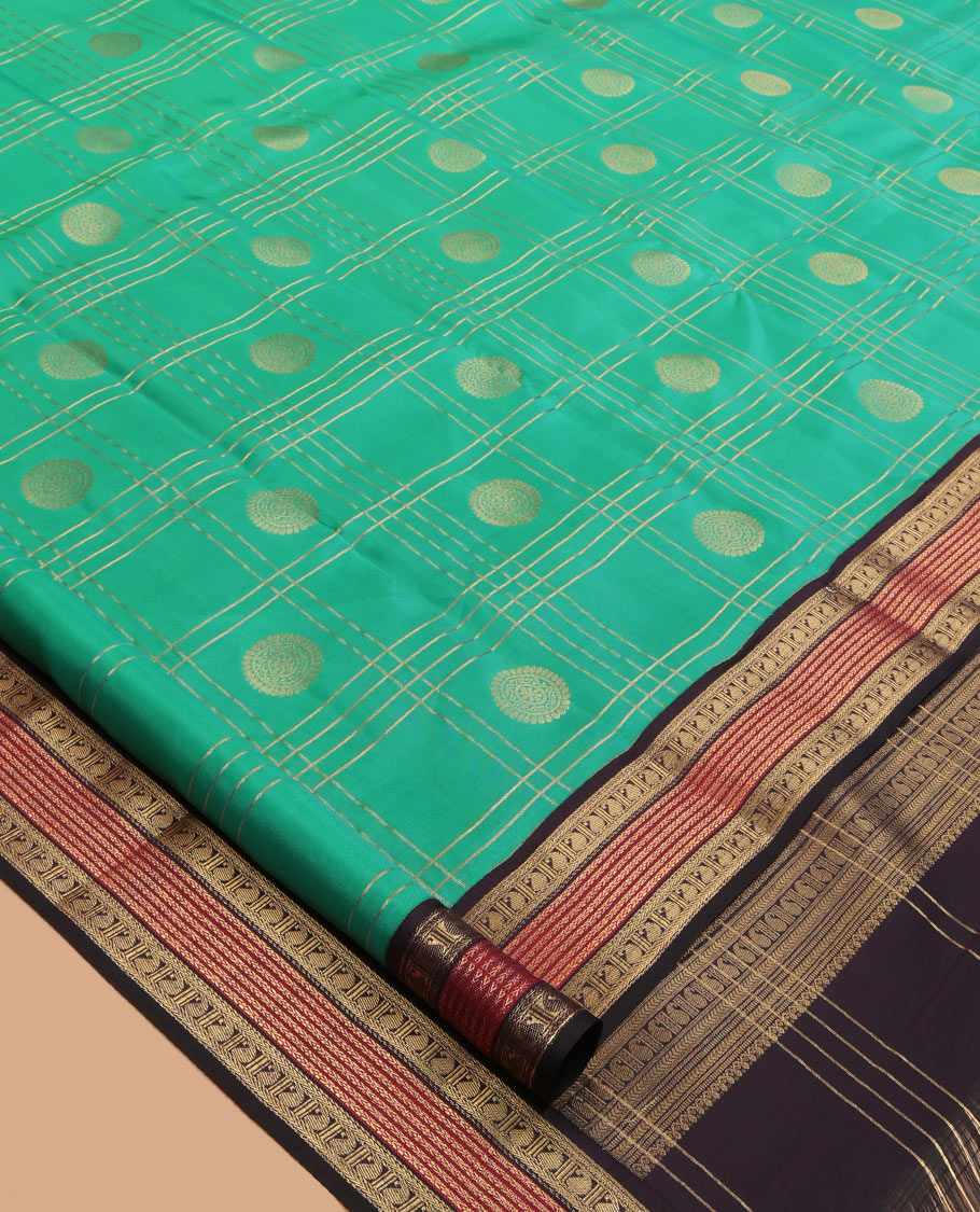 Green Vasundhara Lite Silk Mix Saree Features Butta Enclosed Checks, a Contrast Manga Design Border, Mayil-Chakram Pallu, and Contrast Blouse