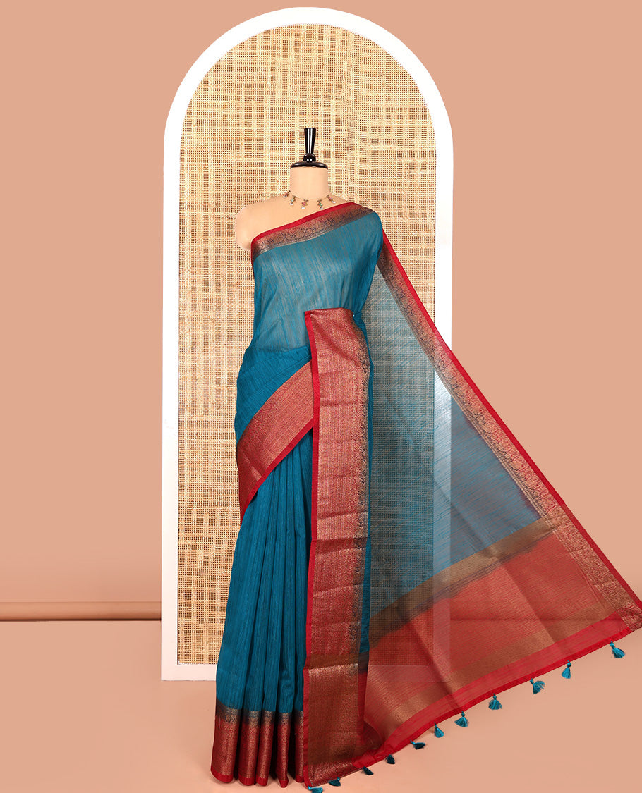 Rama blue plain linen saree, contrast traditional zari design border, striped pallu, and a contrast embroidered blouse