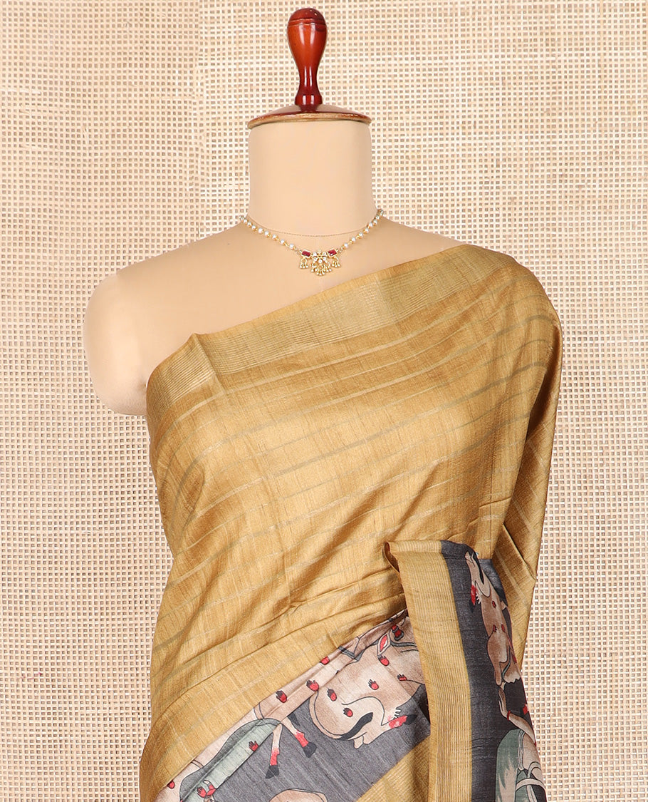 Gold horizontal striped tussar silk saree, Pichwai cow motifs printed border, and striped pallu