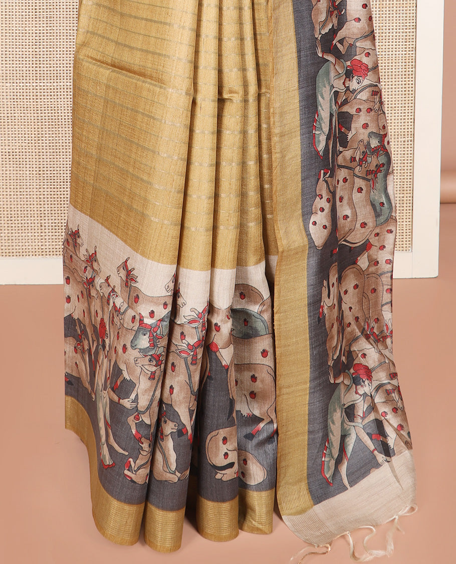 Gold horizontal striped tussar silk saree, Pichwai cow motifs printed border, and striped pallu