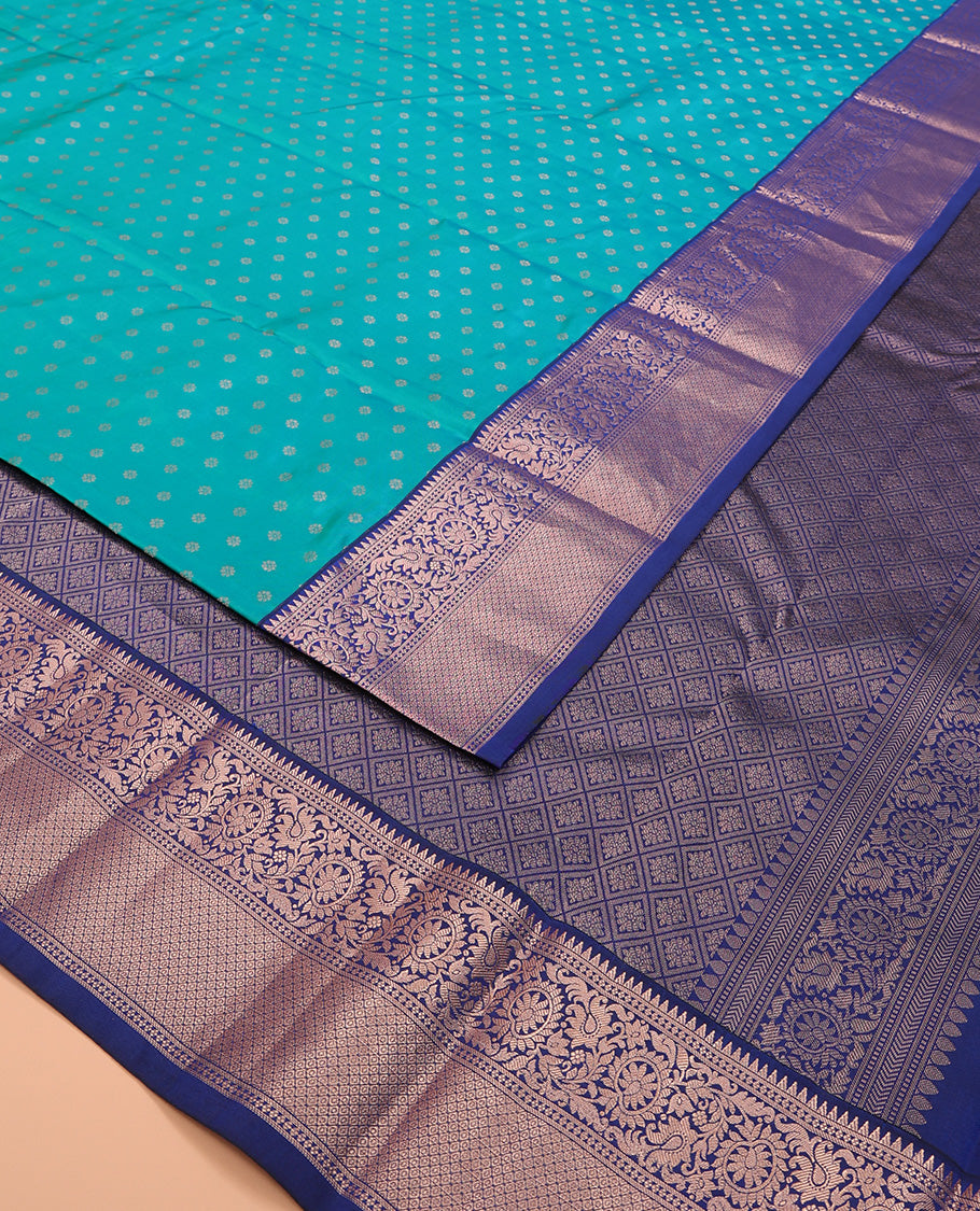 Blue zari buttas Vasundhara silk saree, contrast border of rekku, kodi visiry, and jaal designs, and zari-rich jaal pallu