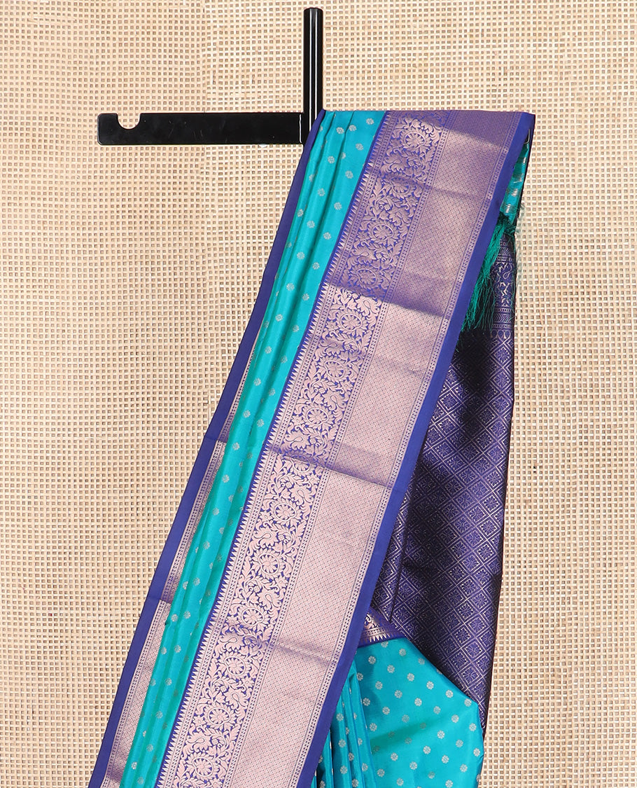 Blue zari buttas Vasundhara silk saree, contrast border of rekku, kodi visiry, and jaal designs, and zari-rich jaal pallu