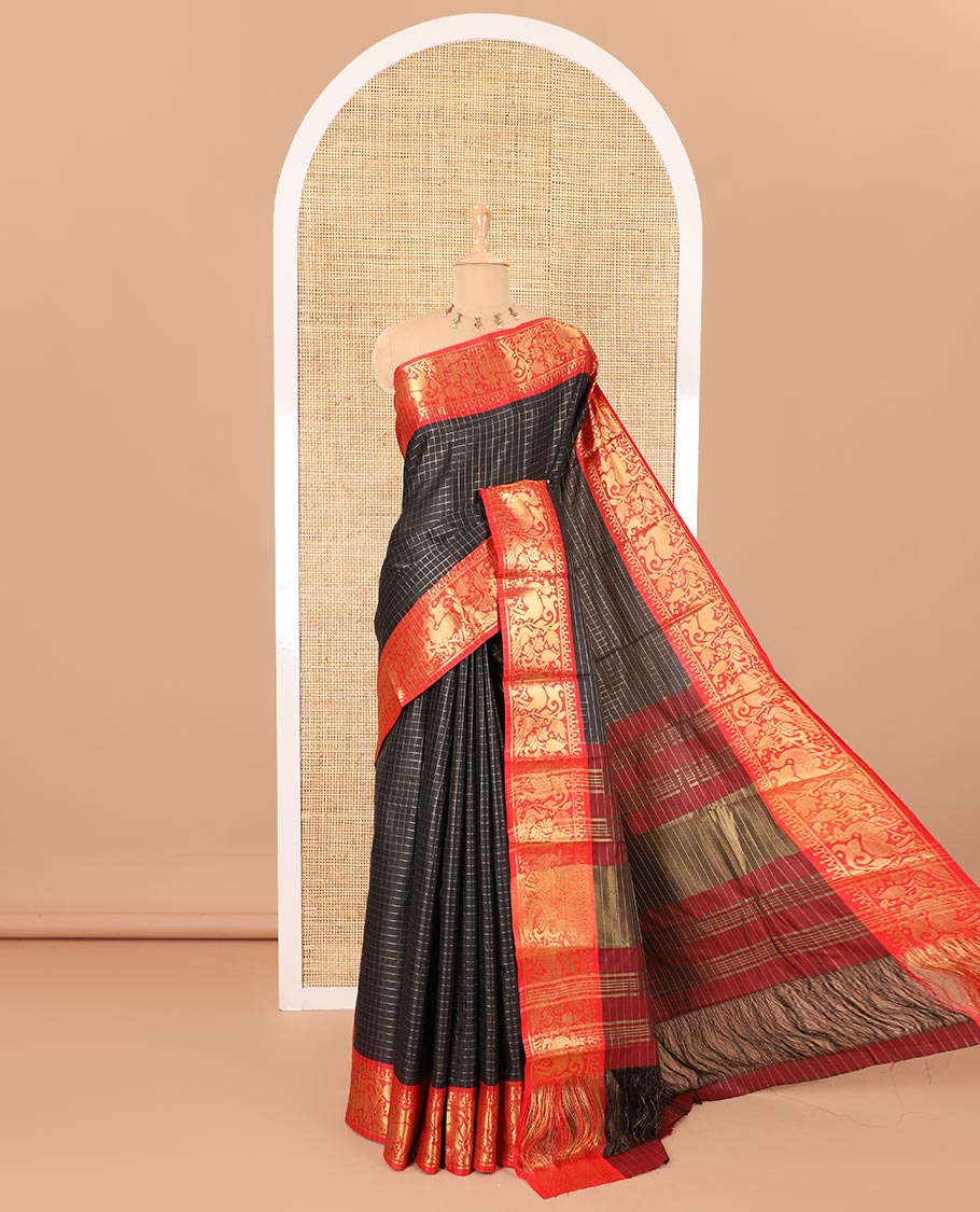 Black golden zari checked semi-taffeta saree, contrast zari border of deer and peacock motifs, striped pallu, and a contrast zari design blouse
