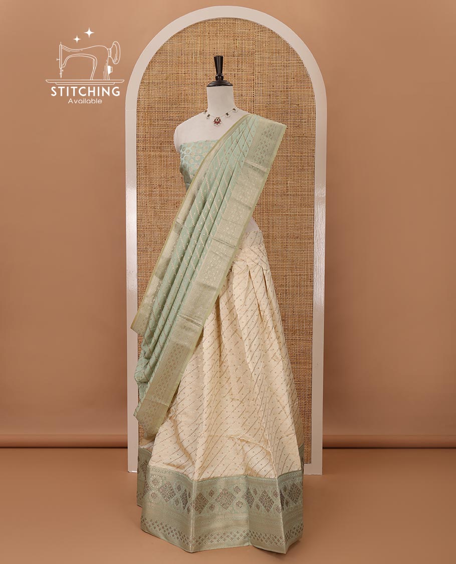 Cream semi-banaras material chudidar,leheriya zari skirt,contrast pista green zari & swarovski stonework border,jacquard blouse & zari weave dhavani