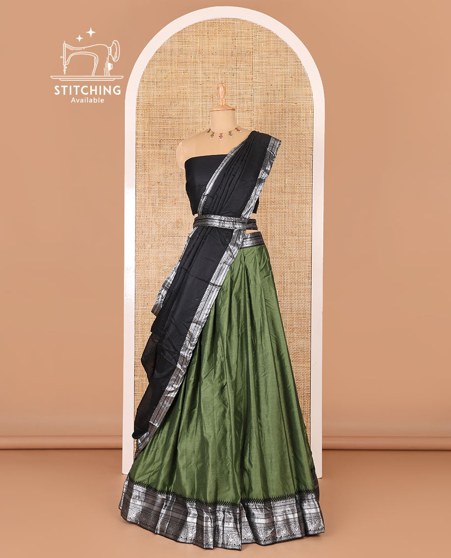 Green taffeta silk half-saree, plain with a contrast traditional design bordered skirt, contrast blouse, and traditional zari bordered blouse