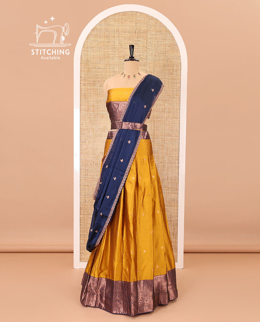 Mustard taffeta silk half-saree, zari buttas with contrast traditional zari bordered skirt, matching zari design blouse, and contrast scallop buttas embroidered dhavani