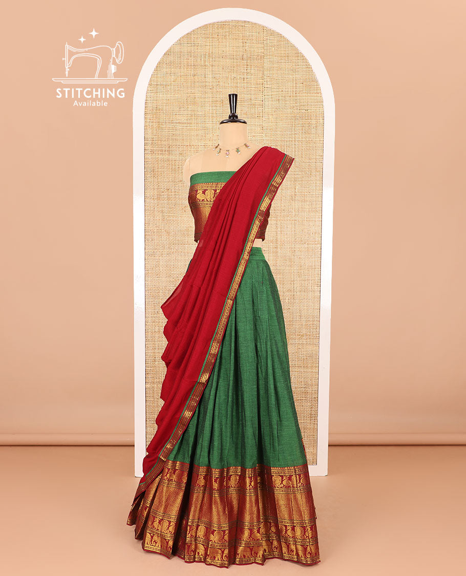 Green half-saree, plain with contrast traditional zari border skirt, matching zari bordered blouse, and contrast zari bordered dhavani