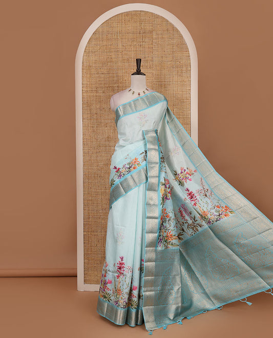 Sky blue tropical floral printed fancy tussar saree, contrast zari traditional design border, intricate Paisley motifs woven zari pallu, and printed blouse