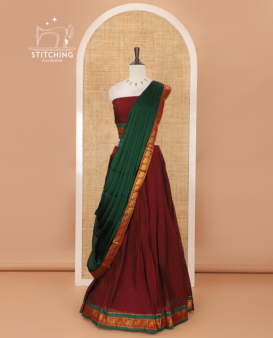 Maroon mercedised cotton half-saree, plain contrast elephant zari border skirt, matching blouse & contrast green zari elephant border dhavani