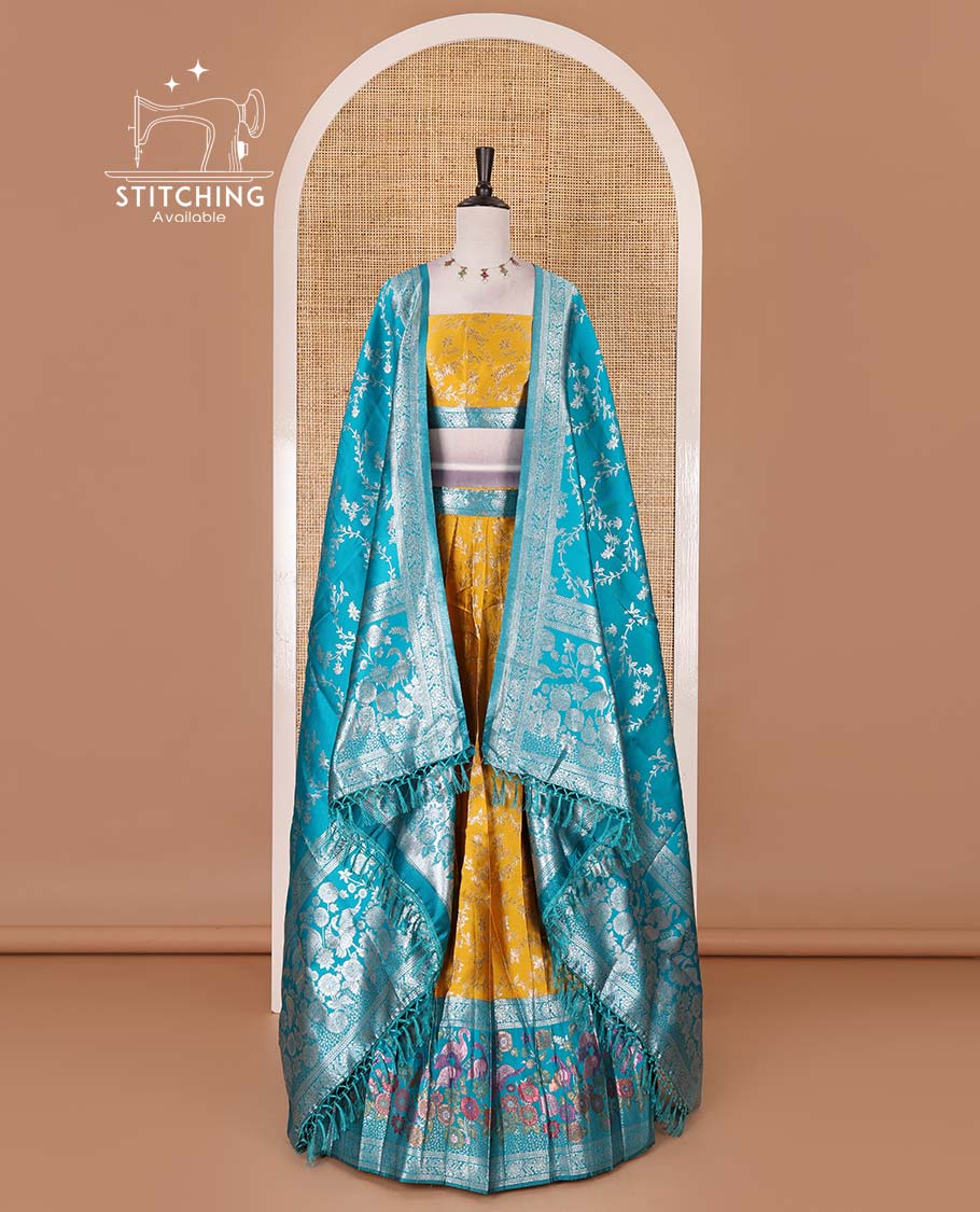 Haldi yellow taffeta silk half saree, floral jaal jacquard skirt, contrast green zari meenakari style bird border, matching blouse, and floral jaal dhavani