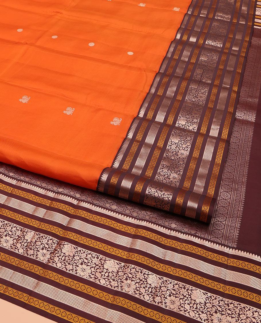 Orange Vasundhara Silk Saree, Adorned with Annam Chakram Buttas All Over Its Body, Complemented by Contrast Border of Thilakam, Neli, Laddu Kamalam, Mayil Kann, and Kodi Visiry Designs, Pallu of Butta Enclosed Checks, and Paired with a Contrast Blouse