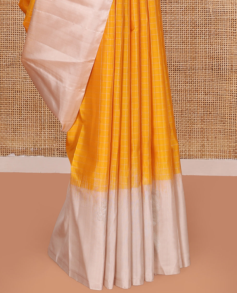 Yellow checked Kanchipuram silk saree, contrast border of zari buttas, and pallu of geometric patterns