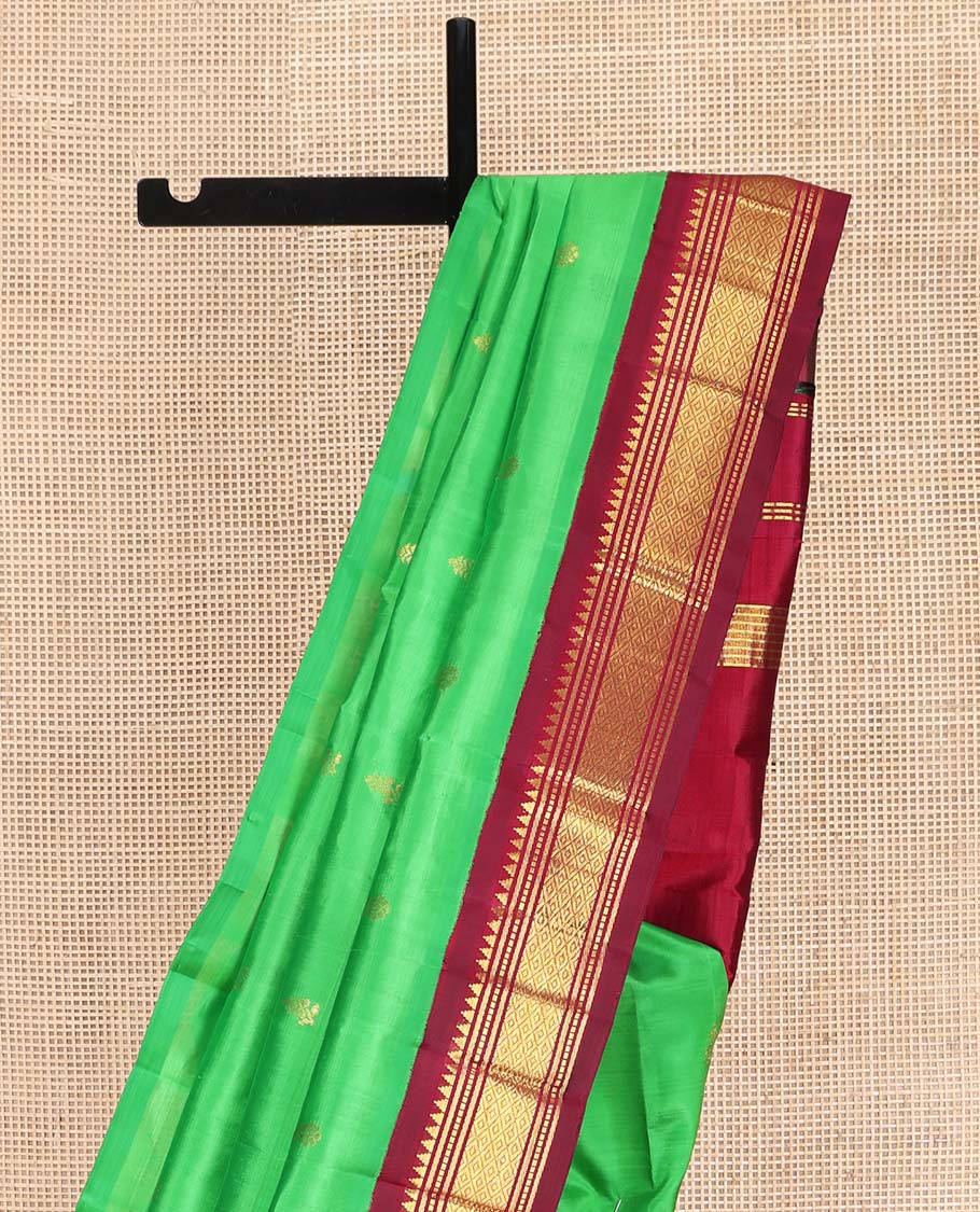Green Kanchipuram Silk Saree, Embellished with Zari Buttas on Its Body, Complemented by a Contrast One-Sided Korvai Border of Rekku, Banaras, Muthu, and Mayil Kann Designs, Pallu Features Zari Designs, and Comes Without a Blouse