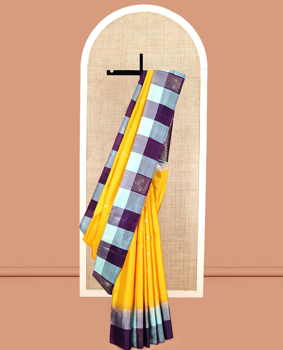 Yellow Kanchipuram Silk Saree, Sparsely Sparkled with Mayil-Chakram Buttas, Complemented by a Contrast Checked Yaanai Motif Border, Floral Pallu, and a Contrast Blouse
