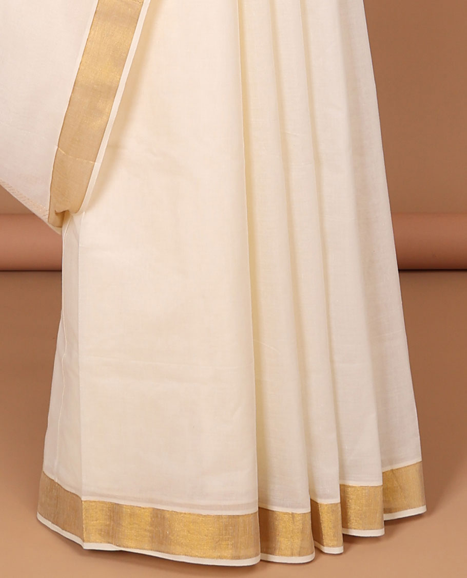 Cream kerala saree with zari stripes, zari border & pallu of traditional designs in zari