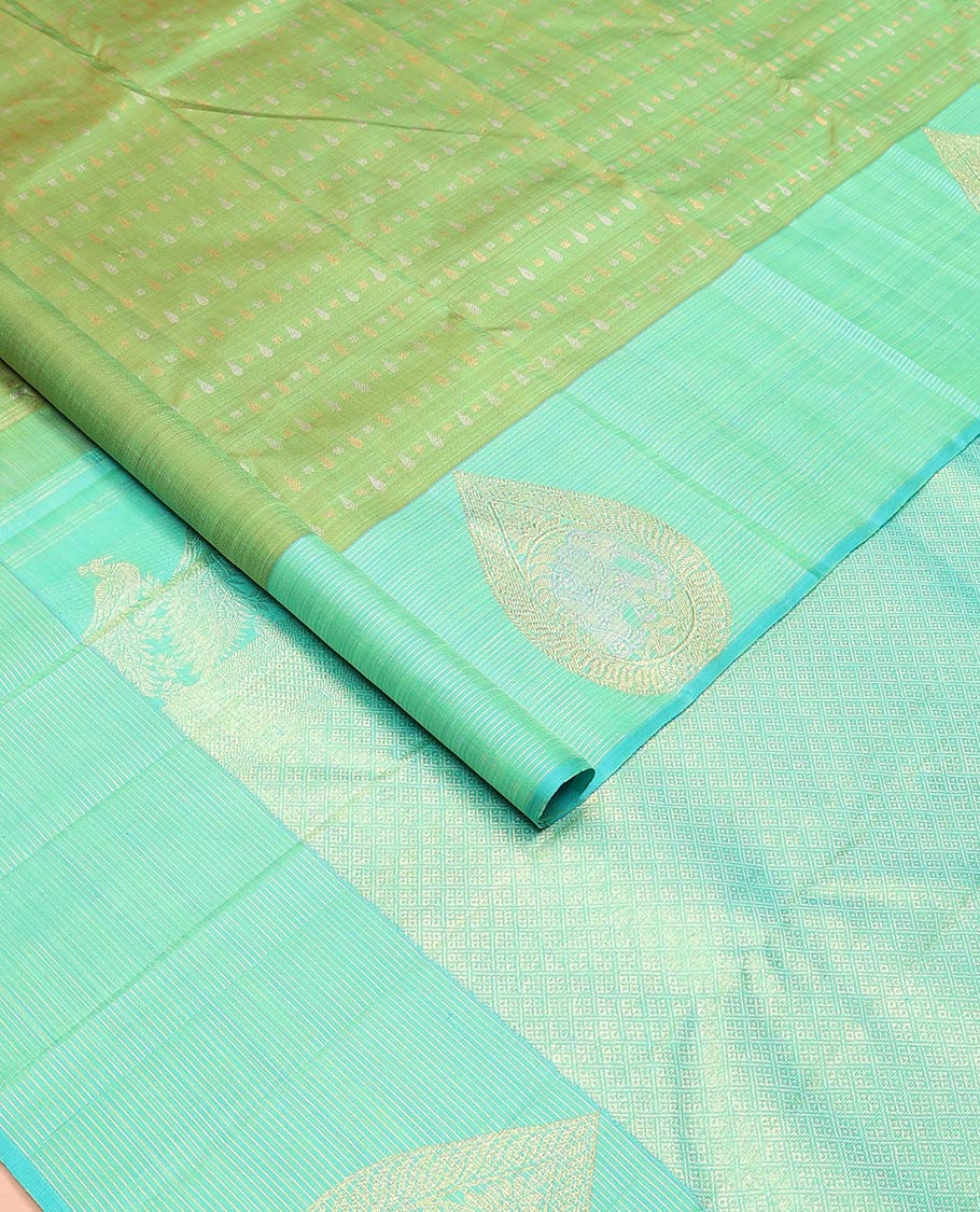 Green zari buttas Kanchipuram designer saree, contrast mayil butta enclosed thilakam design border, and jaal pallu