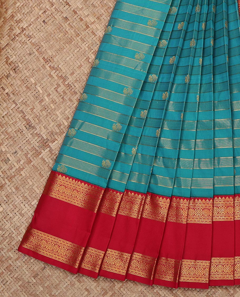 Blue Budget Silk Saree, Gracefully Embellished with Zari Stripes and Peacock Buttas on Its Body, Complemented by Contrast Traditional Zari Design Rettai Pettu Border, Grand Jaal Pallu, and Paired with a Contrast Blouse