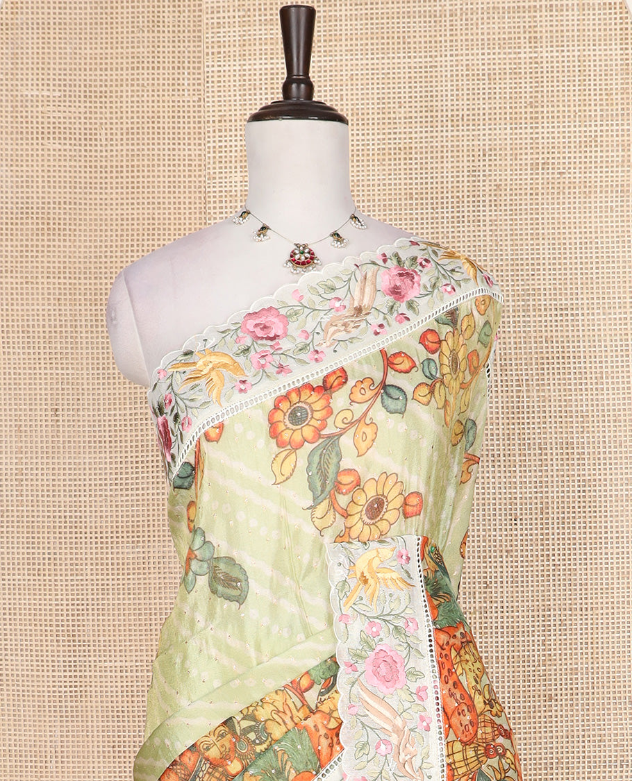 Pastel green buttas with bandhani and kalamkari floral-human motifs printed dola silk saree, contrast floral embroidered scallop border
