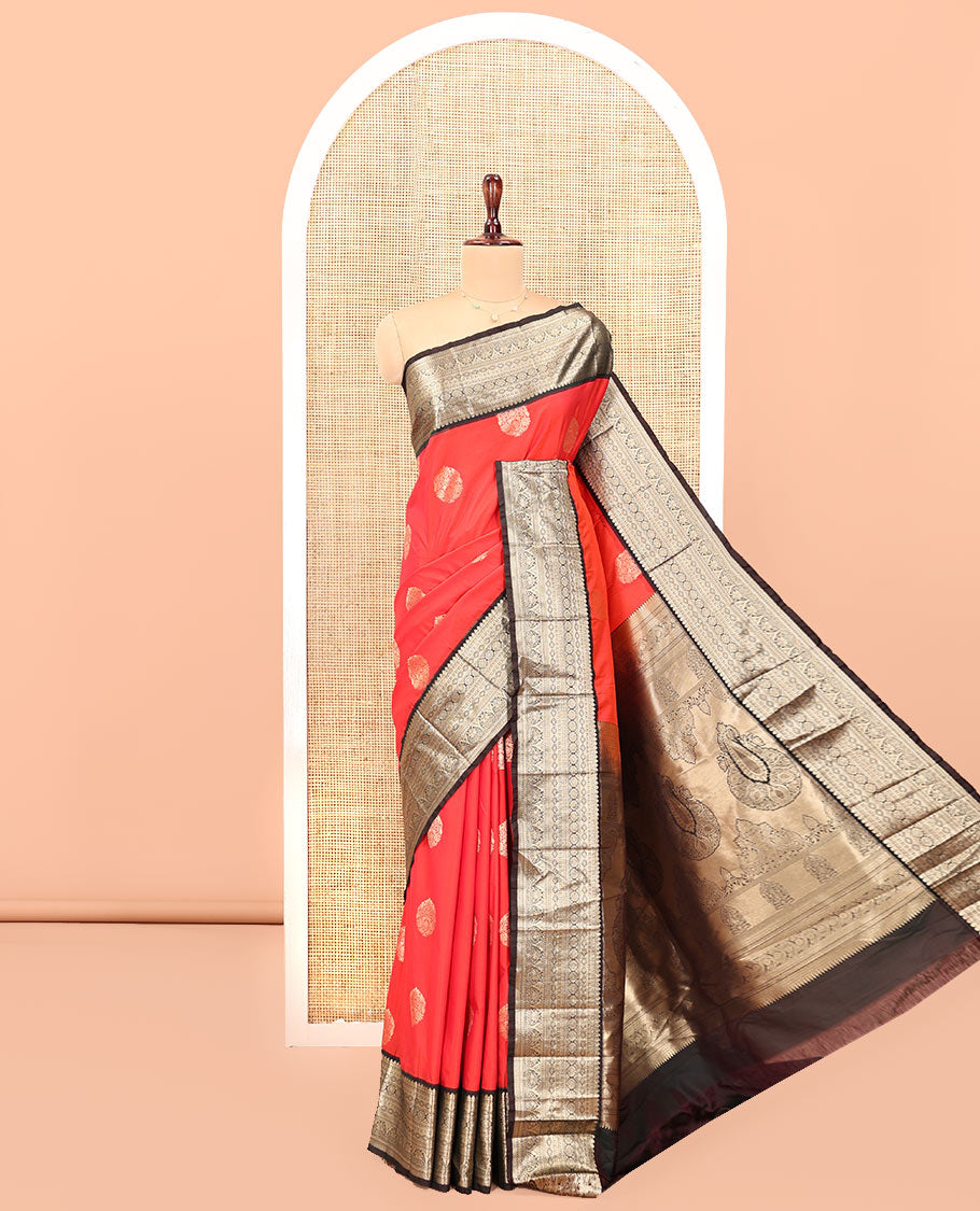 Reddish Orange Budget Silk Saree, Elevated with Floral Zari Buttas All Over Its Body, Complemented by Contrast Traditional Zari Designs Woven Big Border, Grandly Decked Up Pallu, and Paired with a Contrast Blouse