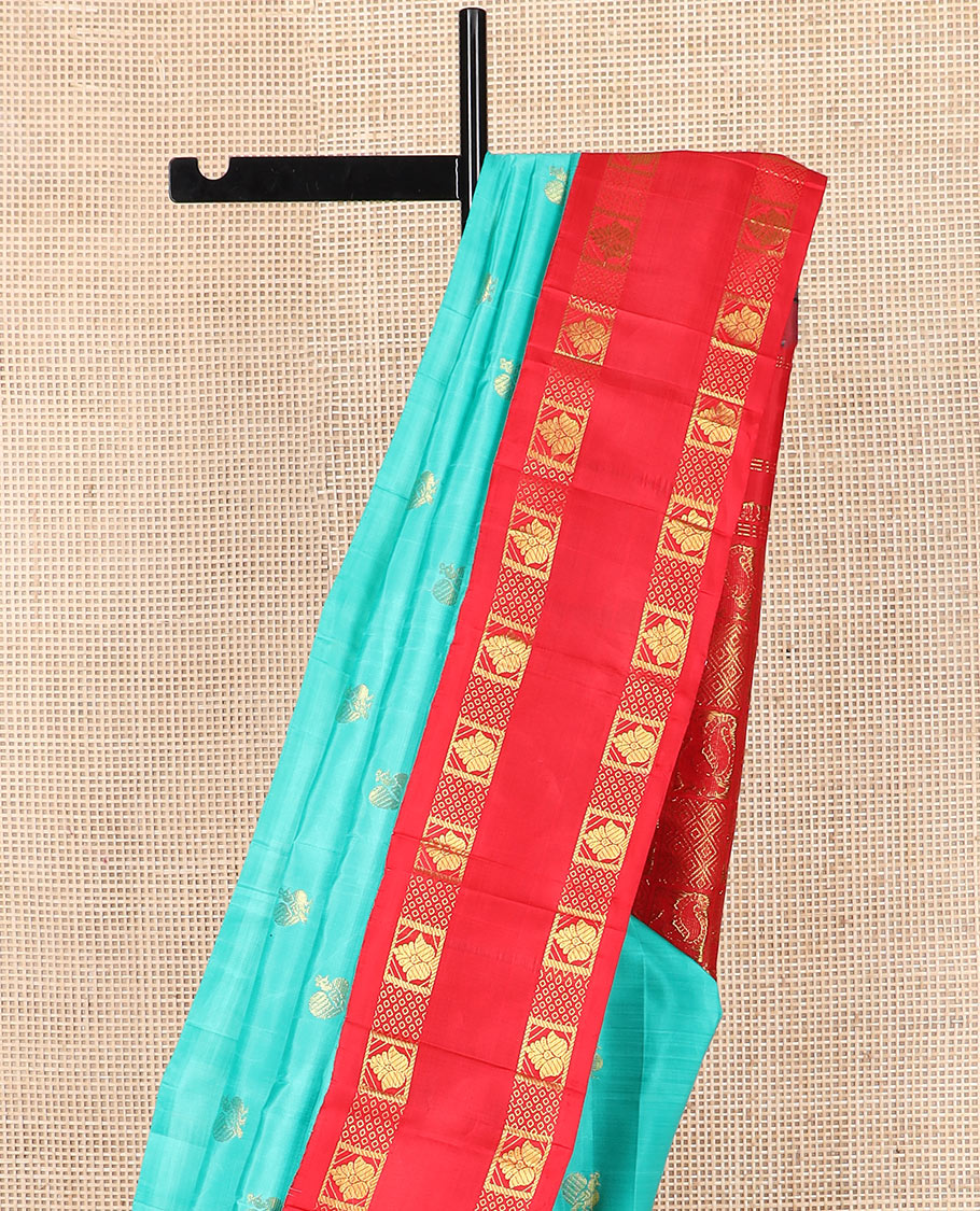 Blue mayil buttas Kanchipuram silk saree, contrast one-sided rettai pettu korvai border of zari designs, and pallu of diamond grid and mayil designs