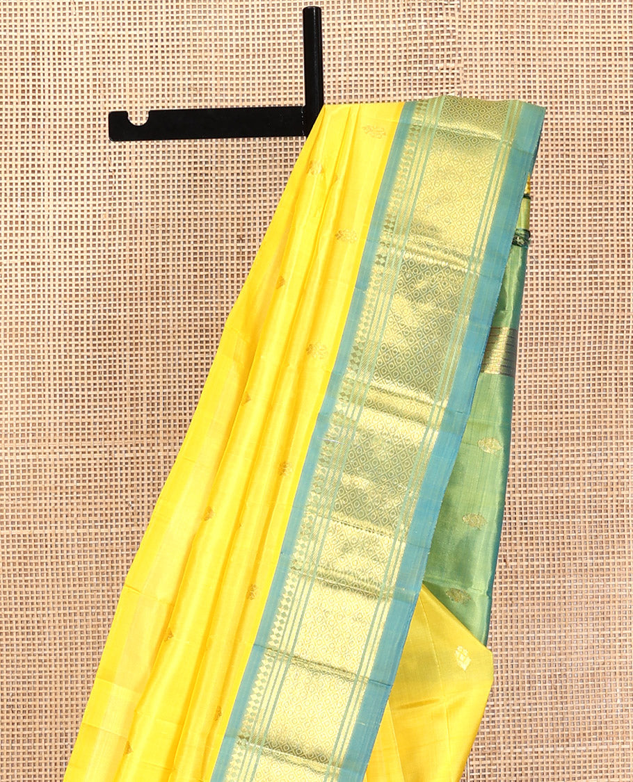 Yellow Kanchipuram Silk Saree, Subtly Sparkled with Zari Buttas, Contrast One-Sided Border of Paneer Sombu, Banaras, and Mayil Kann, Zari Design Pallu, and No Blouse