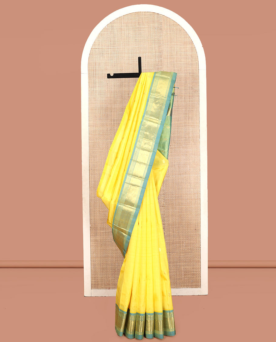 Yellow Kanchipuram Silk Saree, Subtly Sparkled with Zari Buttas, Contrast One-Sided Border of Paneer Sombu, Banaras, and Mayil Kann, Zari Design Pallu, and No Blouse