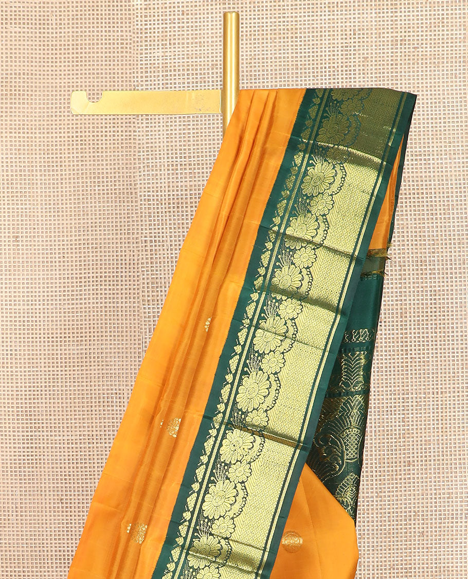 Yellow zari buttas Kanchipuram silk saree, contrast one-sided korvai border of Banaras, floral design & mayil kann & intricate pallu
