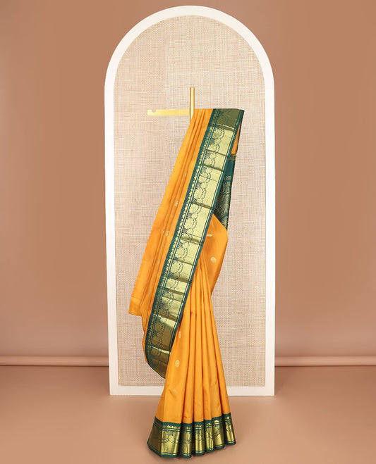 Yellow zari buttas Kanchipuram silk saree, contrast one-sided korvai border of Banaras, floral design & mayil kann & intricate pallu